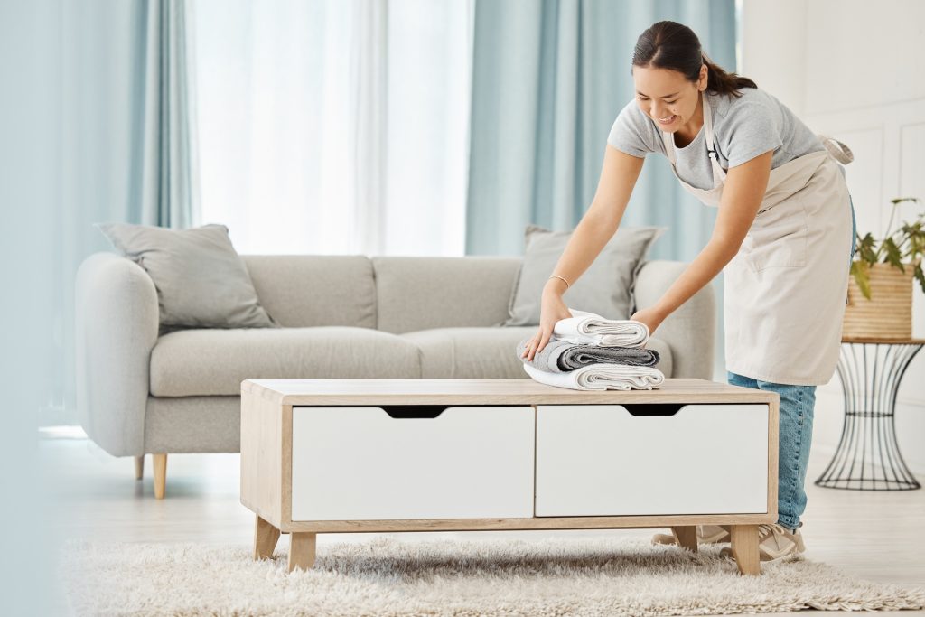 Asian cleaner or woman with towel laundry happy working for luxury hospitality hotel, home or house